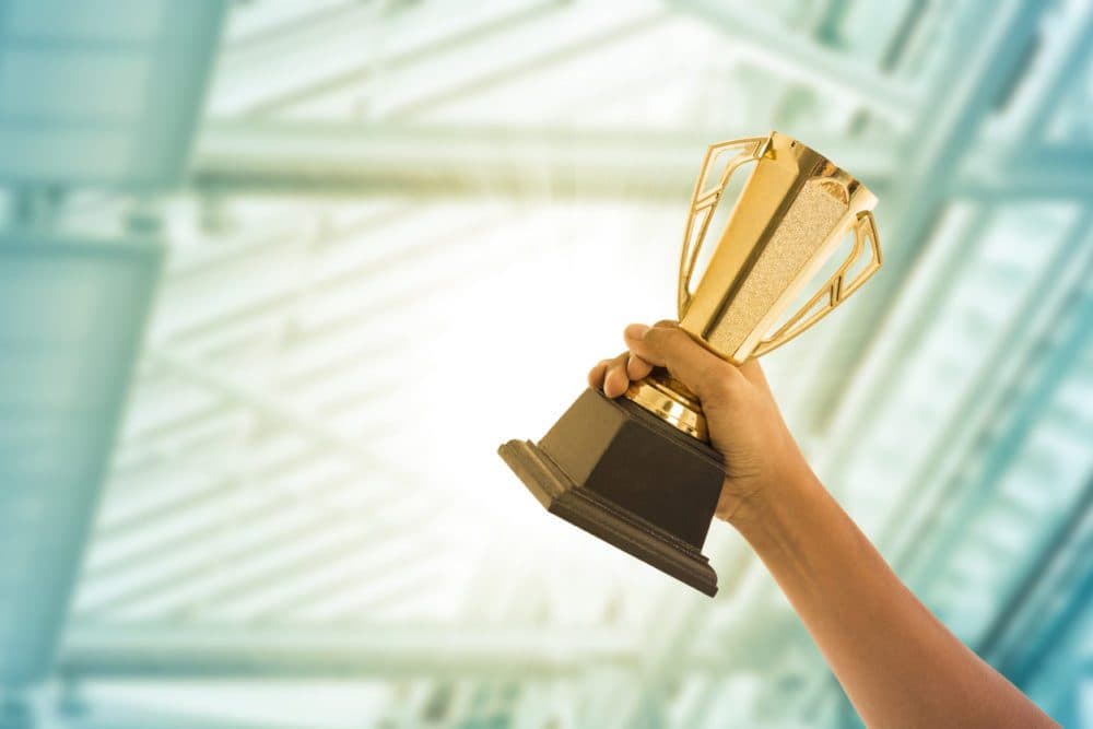 Business people holding trophy award after win competitor.