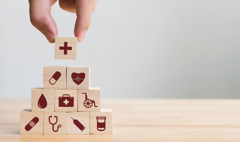 Hand arranging wood block stacking with icon healthcare medical, Insurance for your health concept