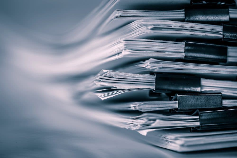 extreamely close up report paper stacking of office working document , retro color tone