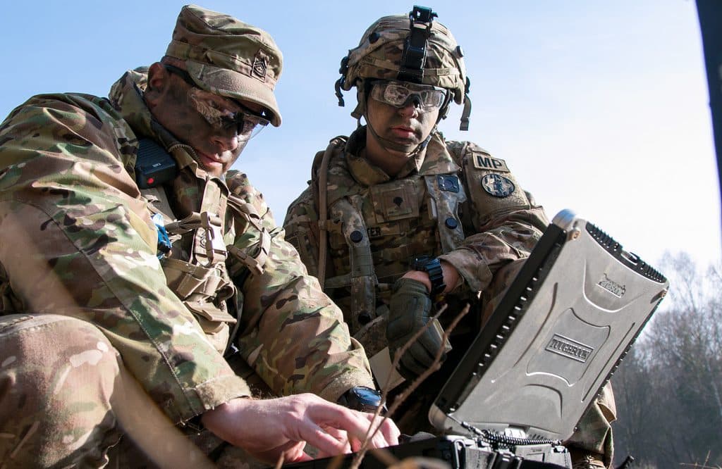 Sgt. 1st Class Joseph Rombold (left), an observer coach at Hohenfels Training Area, Germany, shows Spc. William Ritter (right), a military policeman with 287th Military Police Company, 97th Military Police Battalion, 89th Military Police Brigade, Fort Riley, Kansas, how to properly set up the system to operate the RQ-11 Raven, a small unmanned aerial system (sUAS), during Allied Spirit VIII at Hohenfels, Germany, Jan. 26, 2018. Roughly 4,100 troops from 10 nations are participating in Allied Spirit VIII, a multinational training exercise designed to test participants' readiness and capabilities. U.S. Army photo by Spc. Dustin D. Biven.