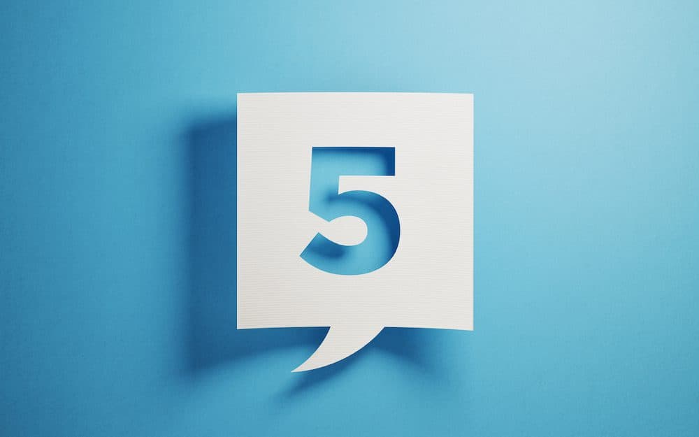 White chat bubble on blue background. Number five writes on chat bubble. Horizontal composition with copy space.