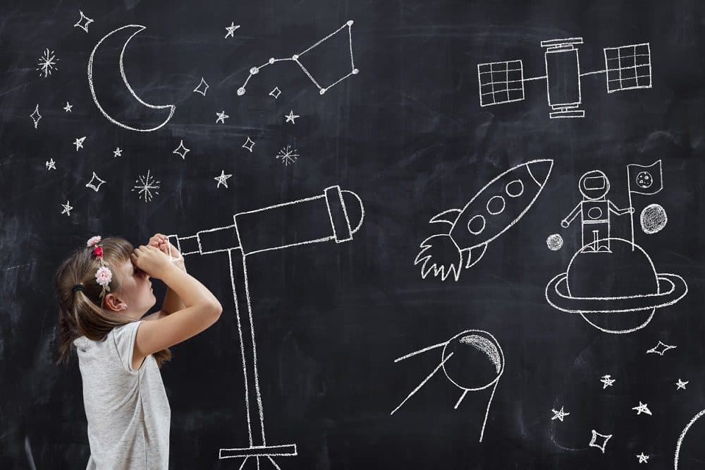 Schoolgirl standing in front of a blackboard, watching stars through a chalk-drawn telescope, learning about space and astronomy