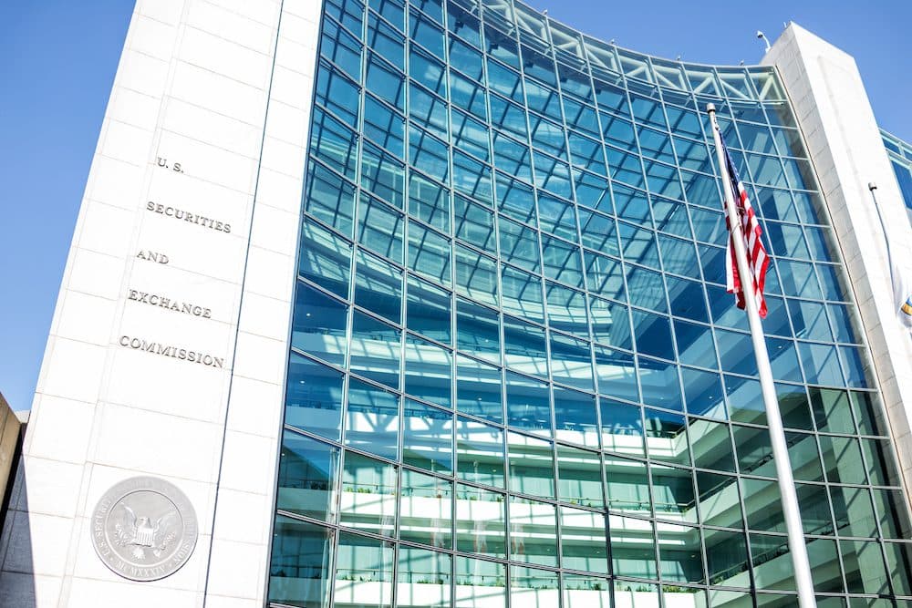Washington DC, USA - January 13, 2018: US United States Securities and Exchange Commission SEC entrance architecture modern building sign, logo, american flag, looking up sky, glass windows reflection