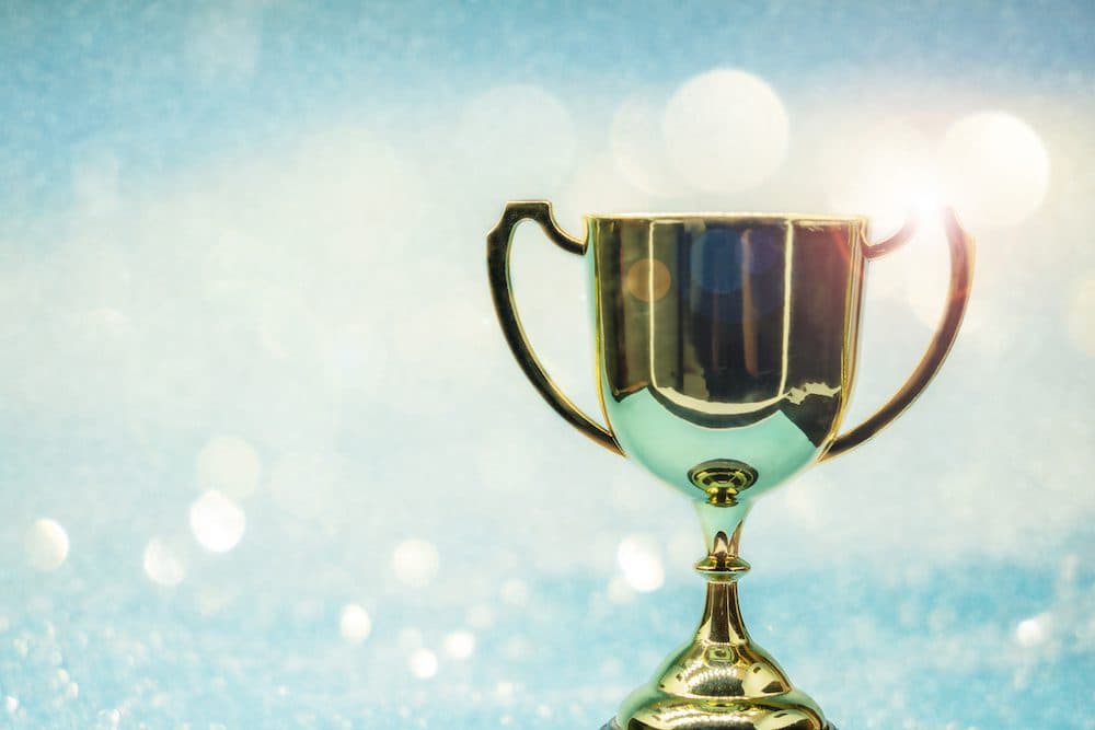 trophy over wooden table and background bokeh.