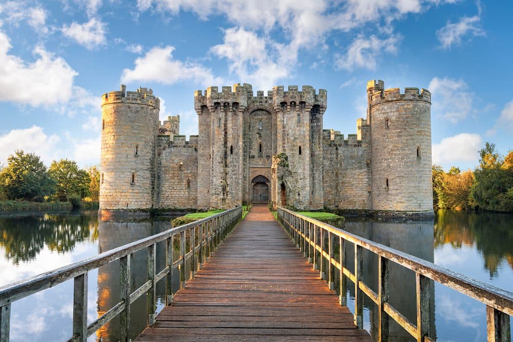Bodiam, United Kingdom - October 3, 2017: Moated castle near Robertsbridge in East Sussex, England as seen at sunrise. It was built in 1385 to defend the area against French invasion during the Hundred Years' War. (Bodiam, United Kingdom - October 3,