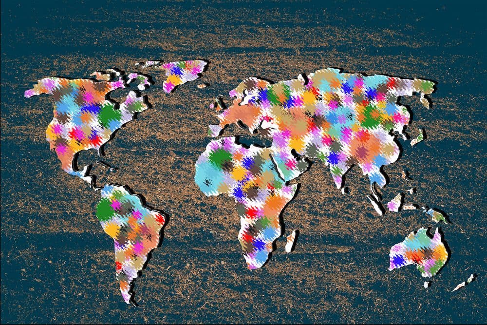 Roughly outlined world map with a colorful background patterns
