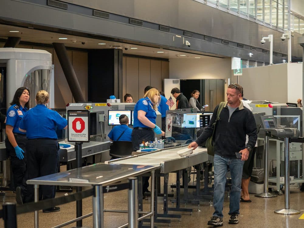 Seattle, WA AUGUST 26, 2018: Man passes though Transportation Security Administration TSA security checkpoint at Seattle-Tacoma International Airport. (Seattle, WA AUGUST 26, 2018: Man passes though Transportation Security Administration TSA security