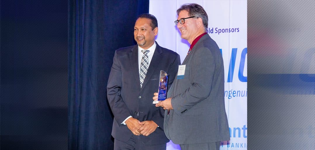 Joshua Gustin is one part of the Federal Aviation Administration group that received WashingtonExec’s Pinnacle Award Government TEAM Project of the Year from SAIC's Sanjay Sardar on Oct. 31.