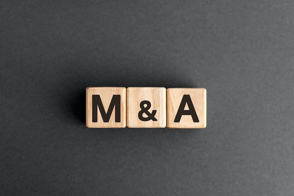 M&A- acronym from wooden blocks with letters, mergers and acquisitions M&A concept, top view on grey background (M&A - acronym from wooden blocks with letters, mergers and acquisitions M&A concept, top view on grey background, ASCII, 114 components