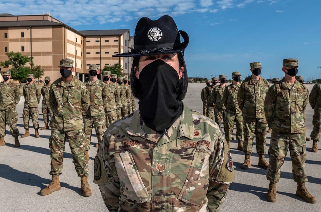 Airmen and training instructors participate in a U.S. Air Force basic military training graduation and coining ceremony, Aug. 27, 2020, for the 331st Training Squadron at the Pfingston Reception Center on Joint Base San Antonio-Lackland, Texas. Graduation ceremonies are closed to the public until further notice for safety and security of the newly accessioned Airmen and their family members due to the coronavirus pandemic. (U.S. Air Force photo by Johnny Saldivar).
