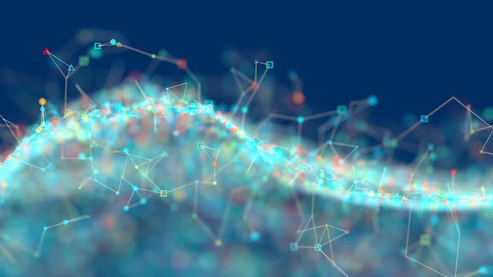 Abstract glowing linked particles on a dark background.Image: piranka/iStock