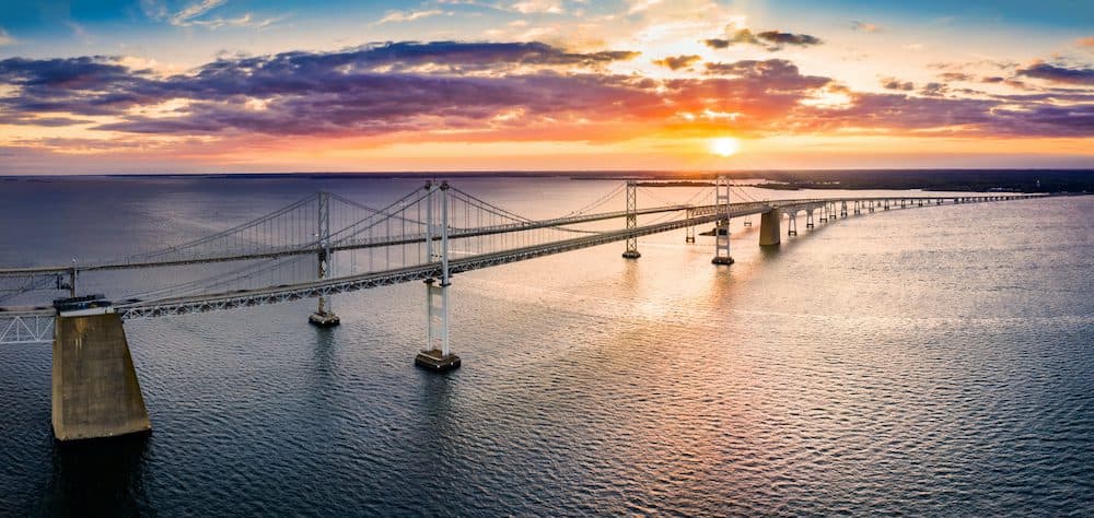 Aerial panorama of Chesapeake Bay Bridge at sunset. The Chesapeake Bay Bridge (known locally as the Bay Bridge) is a major dual-span bridge in the U.S. state of Maryland. (Aerial panorama of Chesapeake Bay Bridge at sunset. The Chesapeake Bay Bridge (