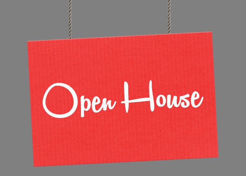 Open house sign hanging from ropes.