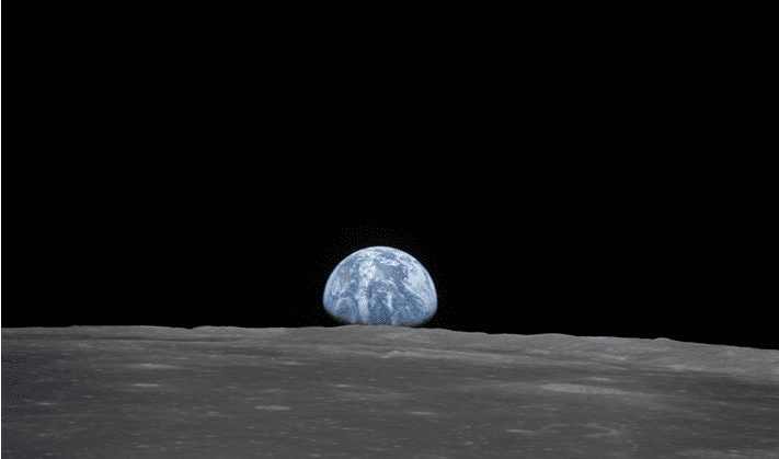 This view from the Apollo 11 spacecraft shows the Earth rising above the Moon's horizon in July 1969. The lunar terrain pictured is in the area of Smyth's Sea on the nearside. Image: NASA