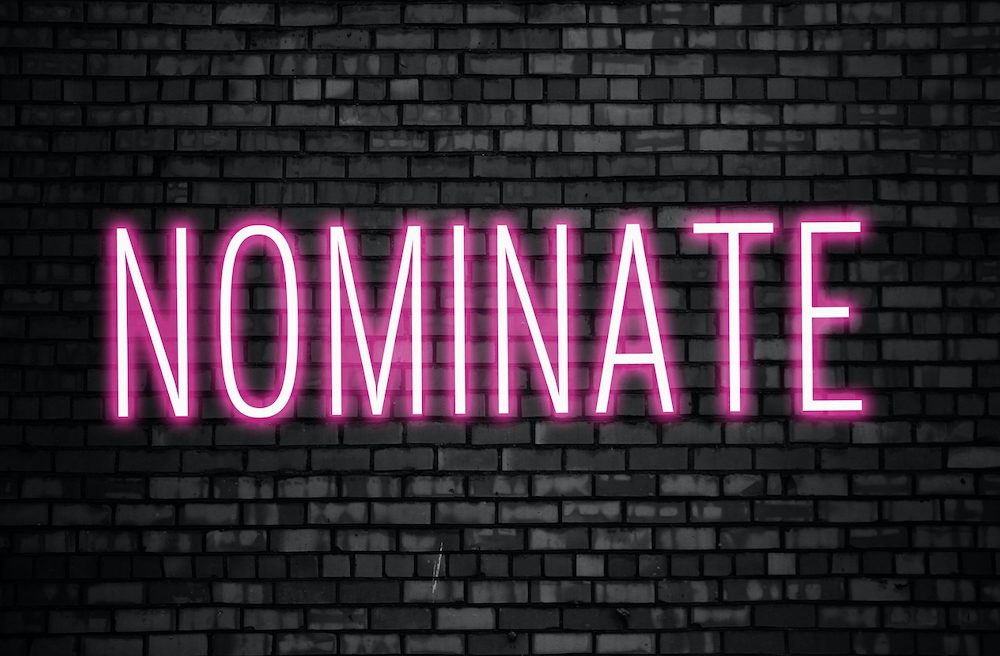 Nominate glowing pink neon sign on black brick wall. Business winner achievement concept for Election Nomination. (Nominate glowing pink neon sign on black brick wall. Business winner achievement concept for Election Nomination., ASCII, 114 components
