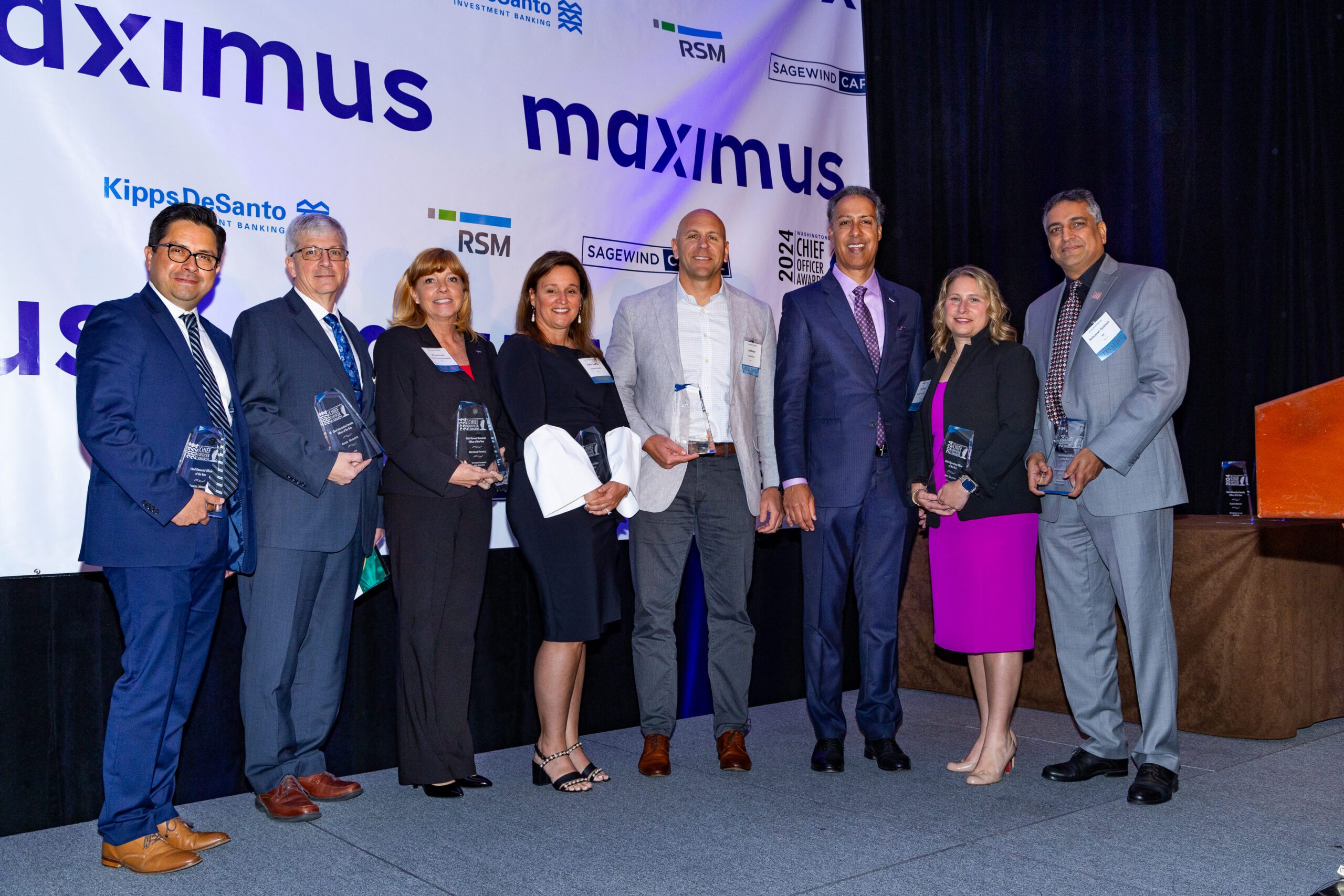 WashingtonExec CEO JD Kathuria stands with some of the winners of the 2024 Chief Officer Awards.    (From left to right: Integral Federal's Manuel Mendez, V2X's Roger Ouellette, SPA's Michelle Howell, Acentra Health's Kelly Loeffler, Royce Geo's Lee Bader, JD Kathuria, Two Six Technologies' Amy Dalton and HII's Ashutosh Gokhale.)