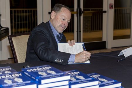 John Hillen signing copies of “The Strategy Dialogues.”